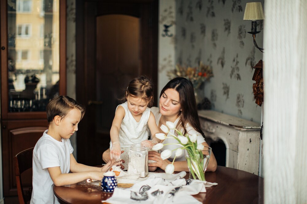 photo-of-woman-sitting-near-the-table-with-her-children-3806967.jpg